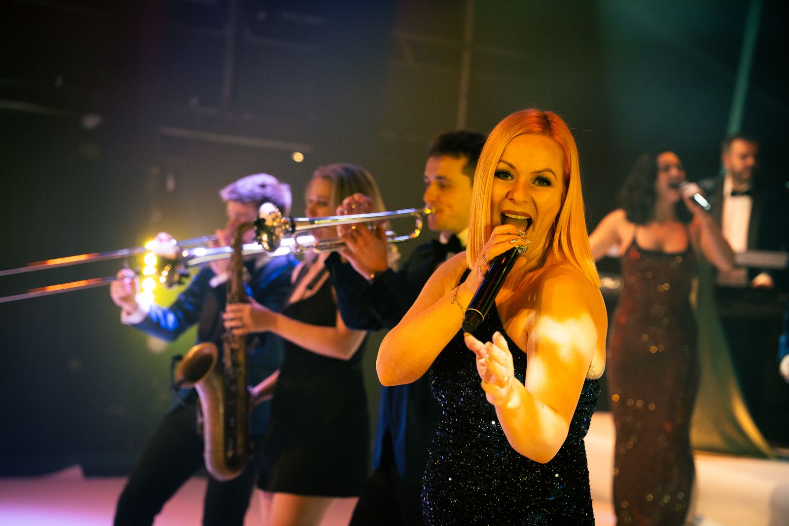 24K Brass Collective vocalist performing